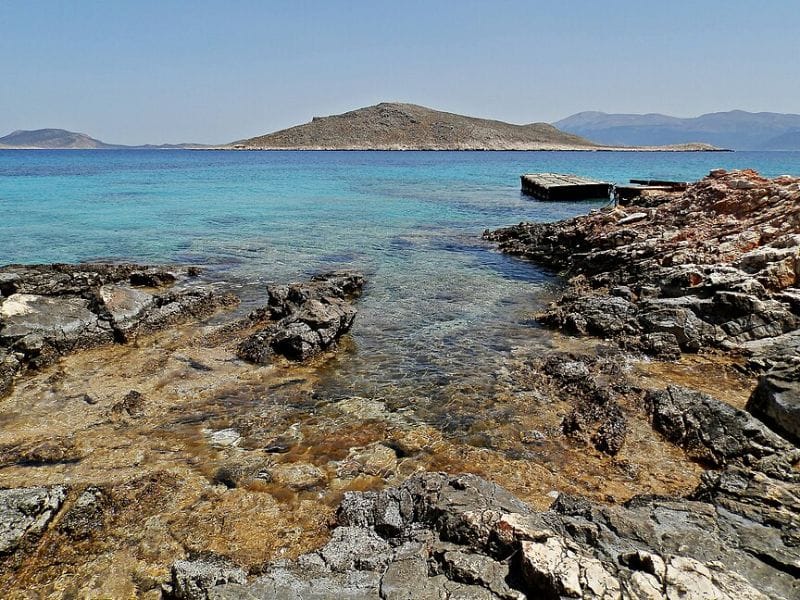 Rocky coastline and turquoise waters near Alimia Island, featured in Alimia Island Tours in the Aegean Sea.