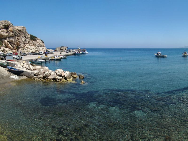 Small harbour and crystal-clear sea near Alimia Island, connected with Alimia Island Tours from Rhodes.