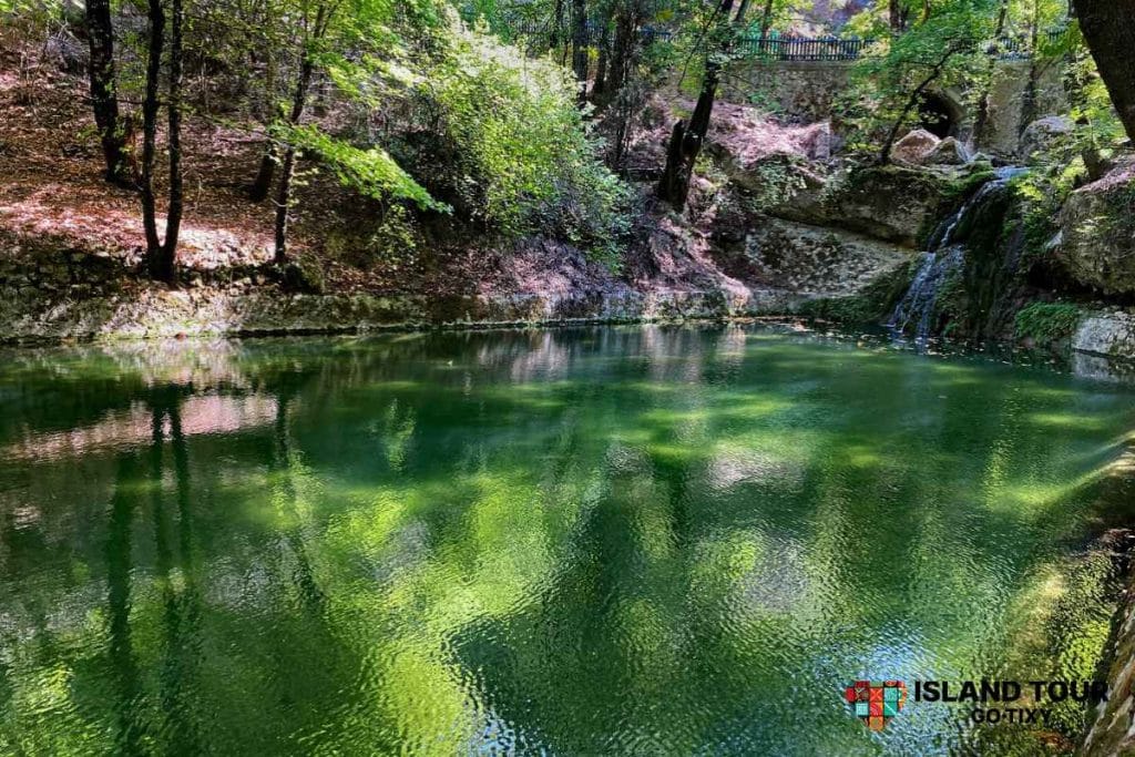 Green pond and waterfall in the Valley of the Butterflies, featured in Butterflies Valley Tours in Rhodes.