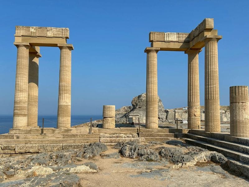 Ancient Doric columns and archaeological ruins at the Acropolis during Lindos tours.