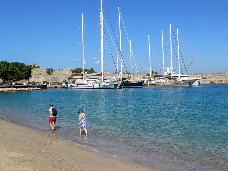 Luxury yachts and medieval harbor scenery featured in Rhodes Boat Trips.