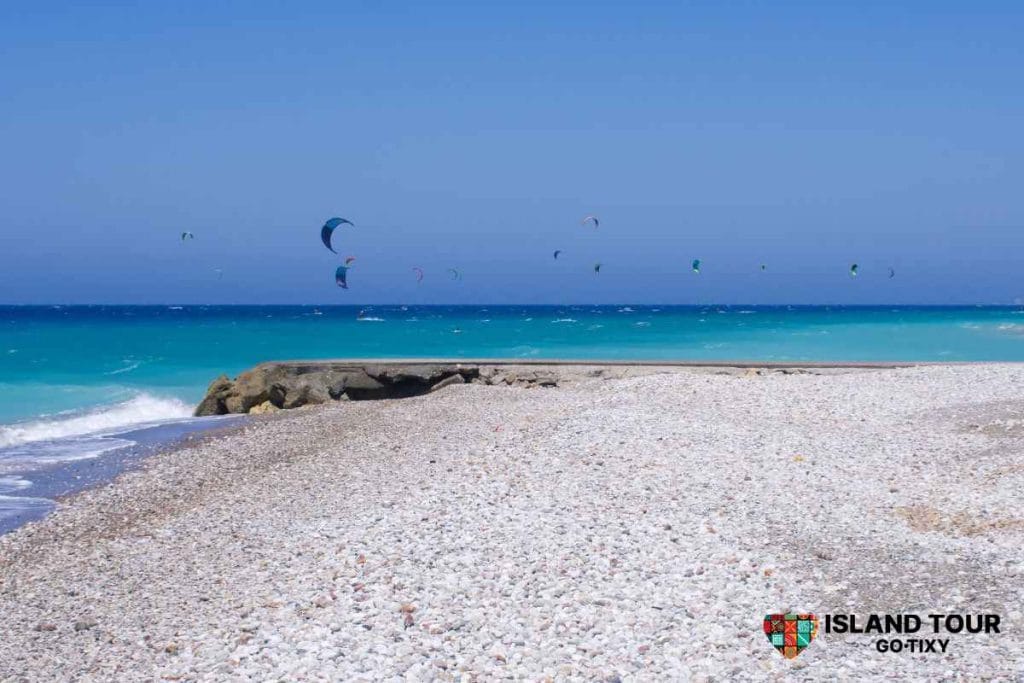 Pebble beach and turquoise coastline featured in Rhodes Horseback Riding routes.
