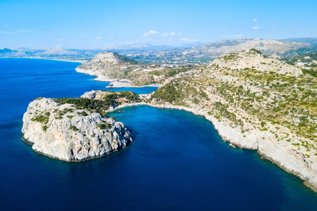 Turquoise sea and rocky coastline along the East Coast Rhodes shoreline.