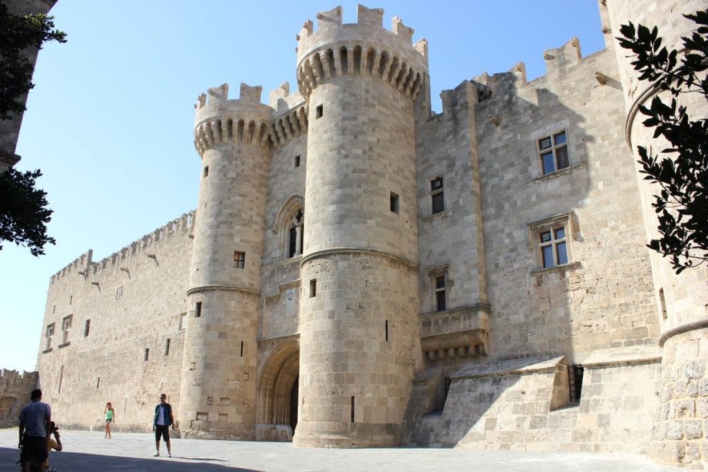 Medieval stone buildings and arcades on a Rhodes Old Town walking tour.