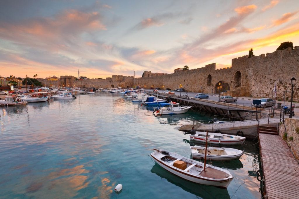 Mandraki Harbour and medieval walls featured in Rhodes audio guides.