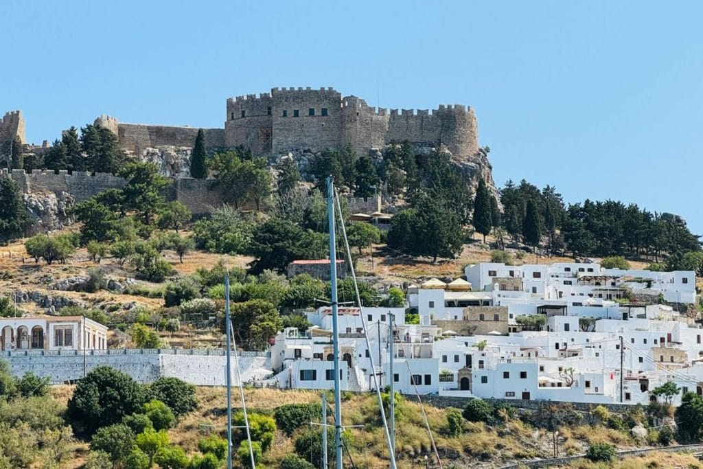 Lindos village and acropolis viewed during a cruise in Rhodes.