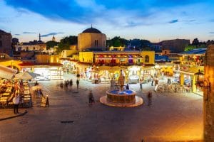 Visitors enjoying the evening atmosphere in Rhodes Old Town during a full day in Rhodes.